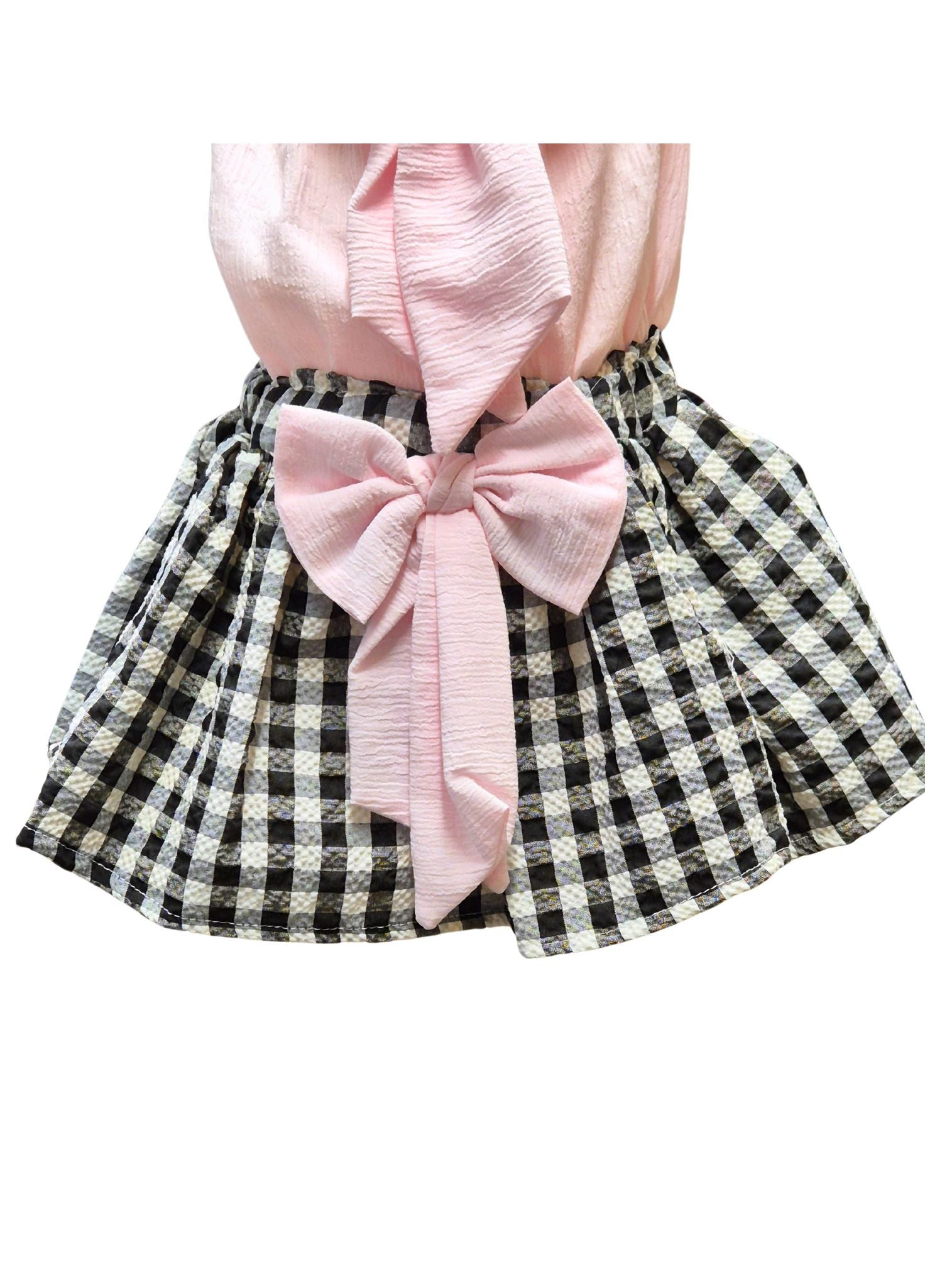 Checkered skirt with a large pink bow on a white background