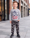 boy in grey and black camo joggers with a grey top with Off Road Adventures on the front
