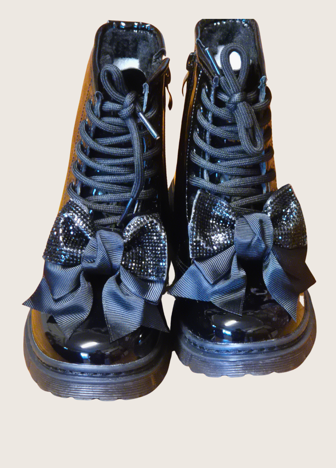 Pair of girls black patent boots with sparkly bows on the front