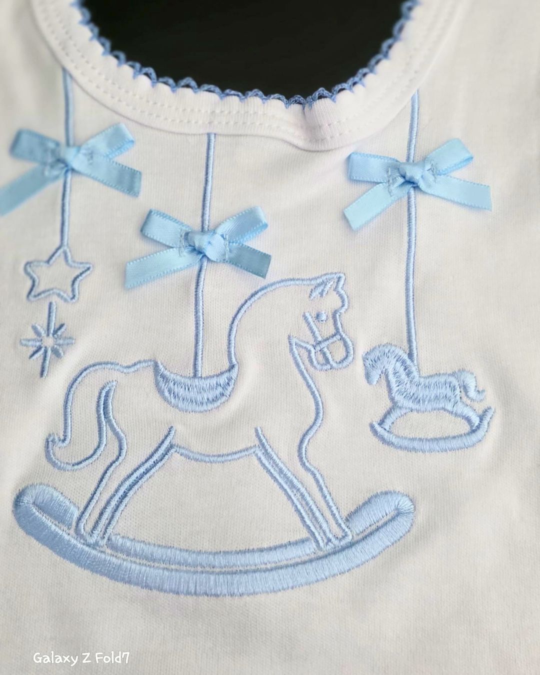 Blue rocking horse bib with Velcro fastening