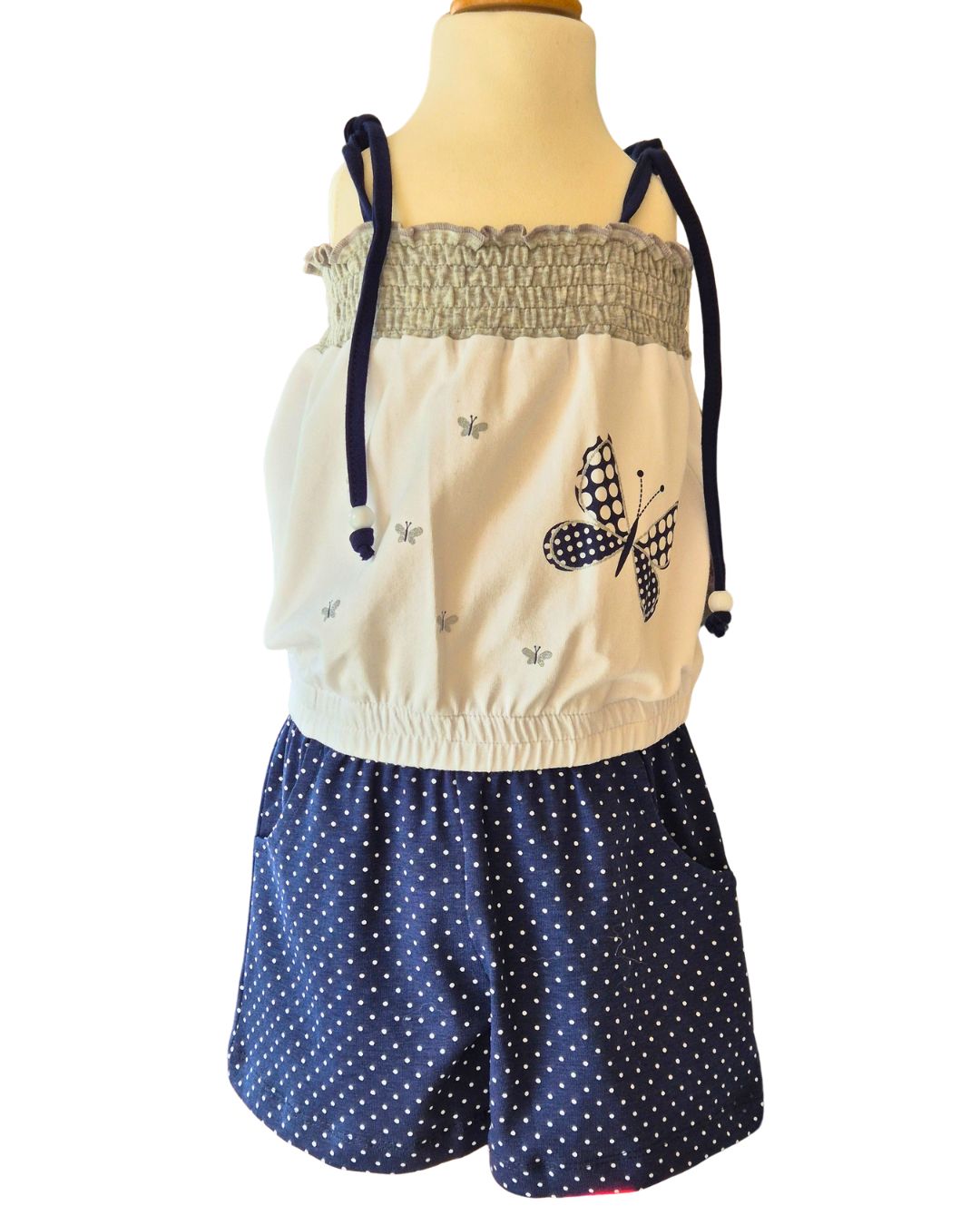 Girls blue polka dot butterfly playsuit front view