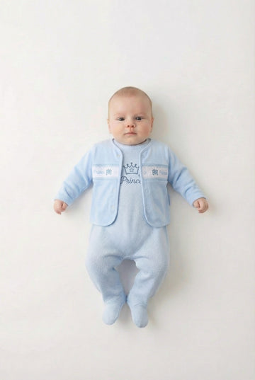 Baby boy in a matching blue romper and smocked jacket that features a crown and the word Prince.