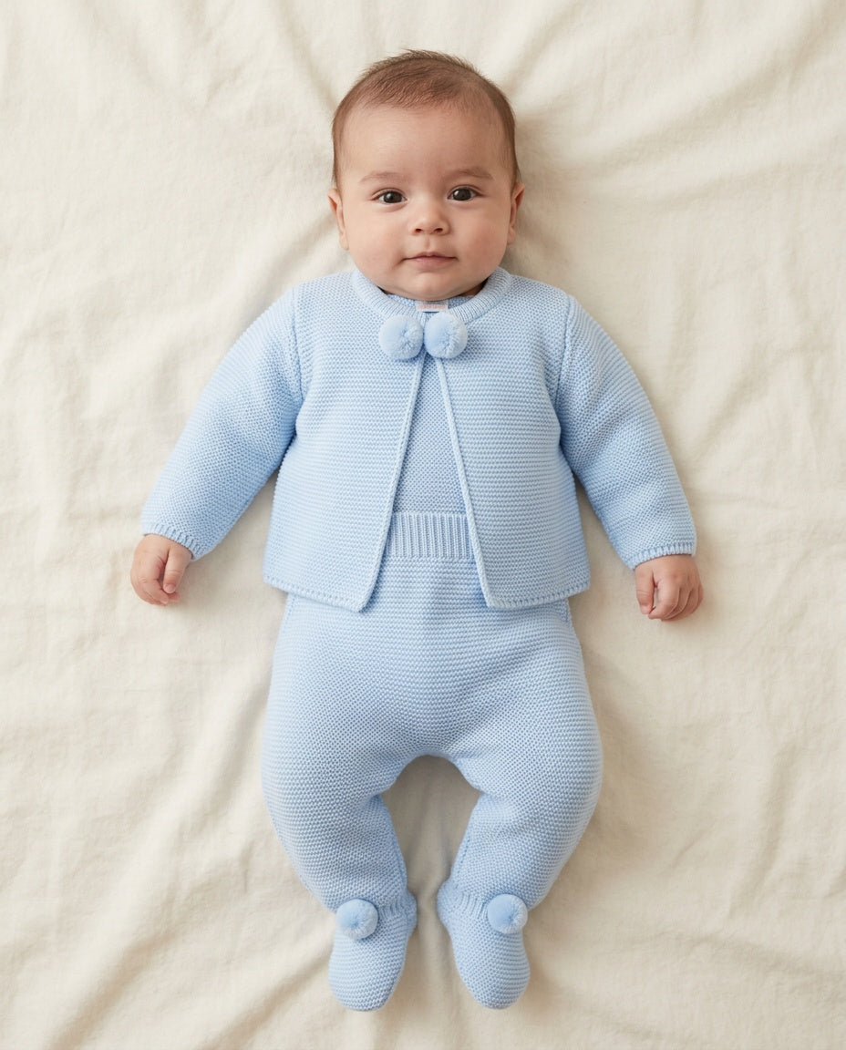 Baby blue knitted newborn boy cardigan and footed trousers set with matching pom pom details