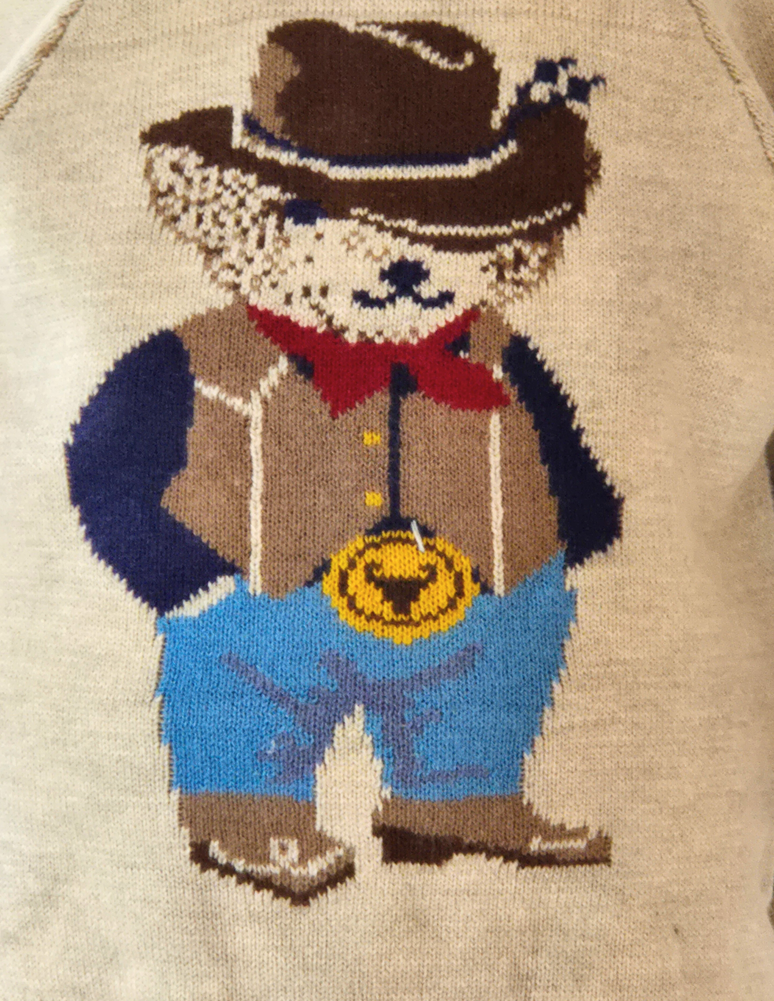 Detail of the cowboy bear with his hat, neckerchief, big belt buckle and cowboy boots