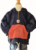Black and rust corduroy hoodie on a mannequin with a white background