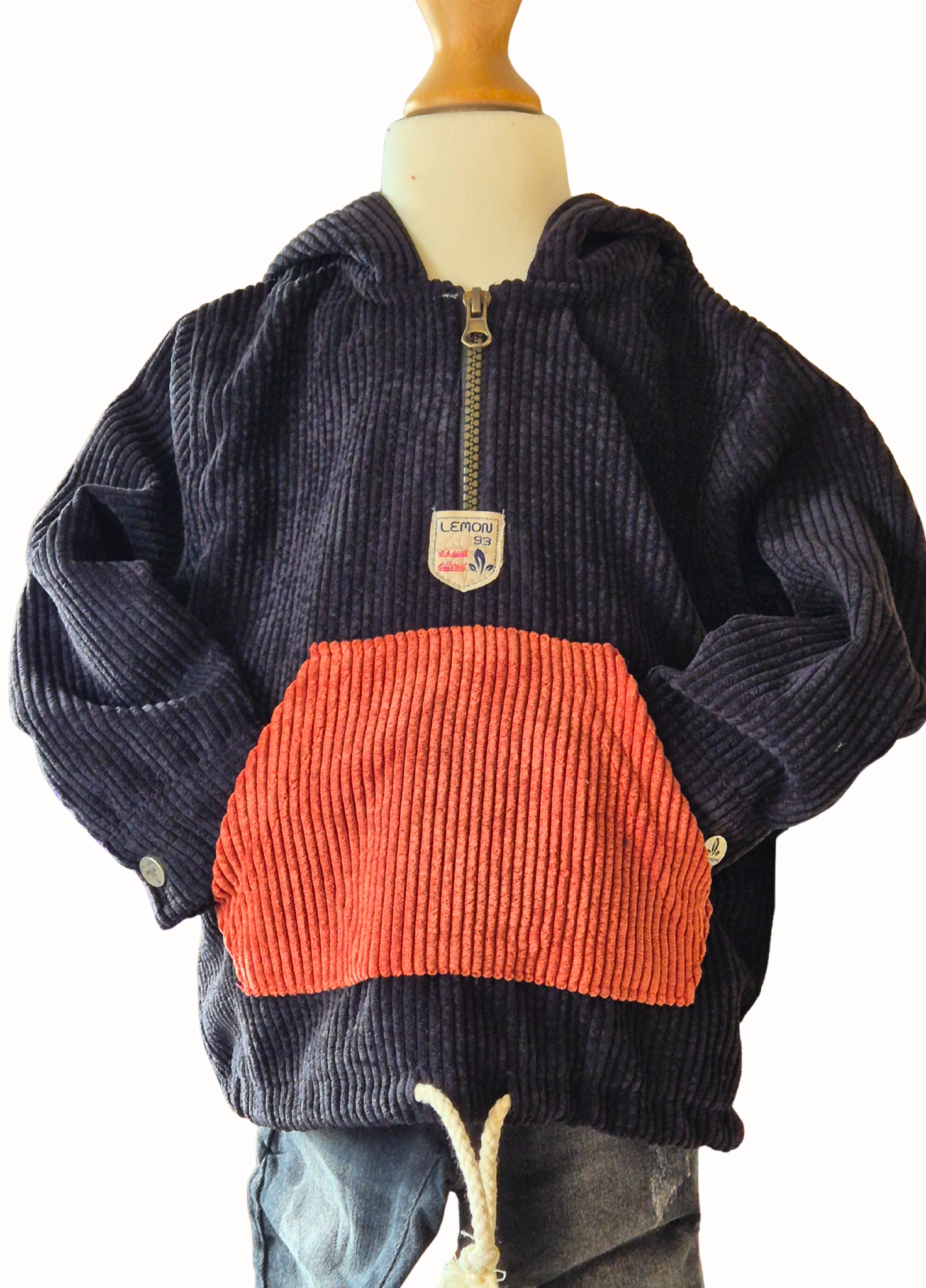 Black and rust corduroy hoodie on a mannequin with a white background