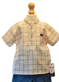Plaid shirt on a mannequin with a visible brand tag against a white background