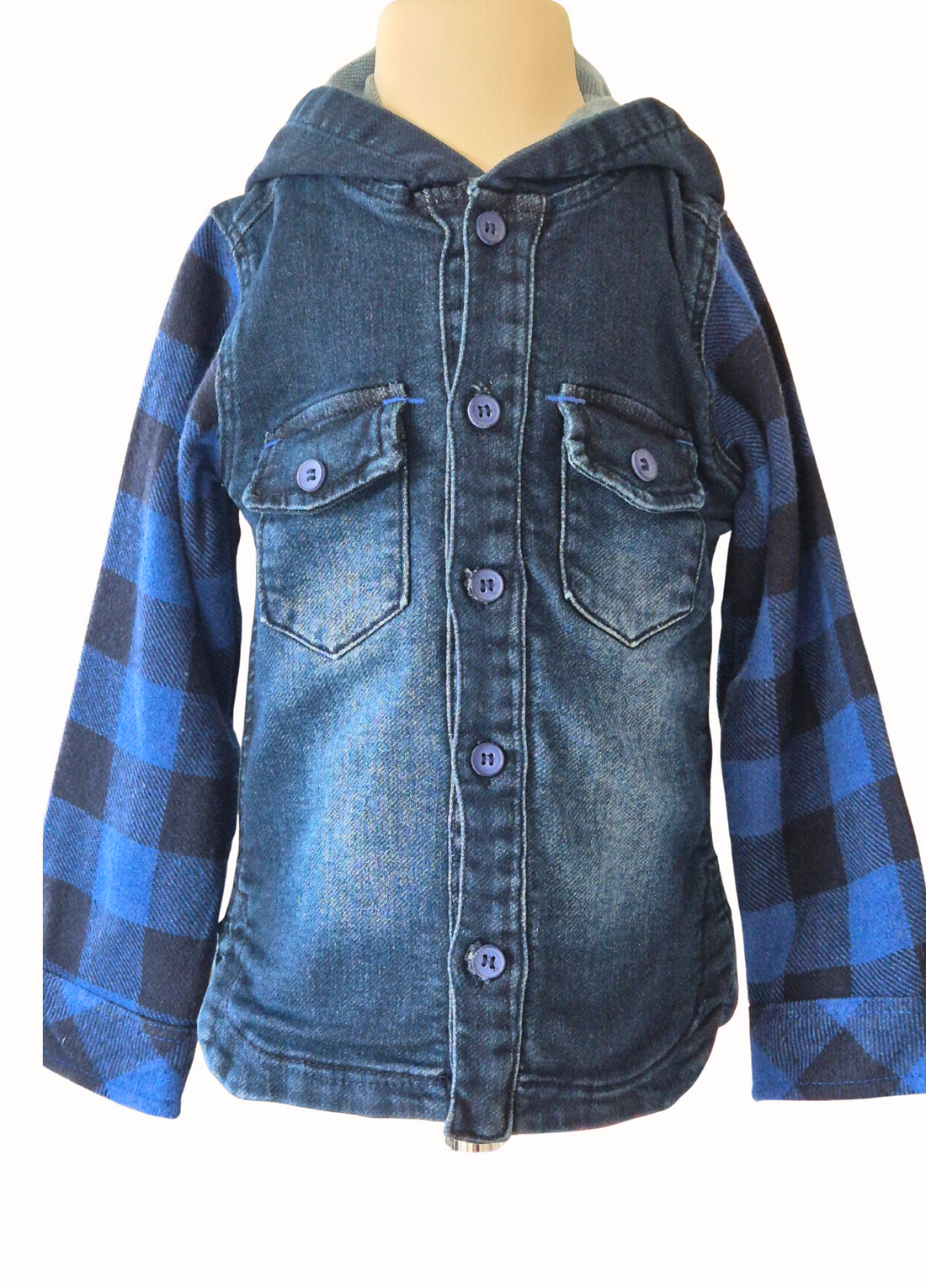 Blue denim hooded shirt with plaid sleeves on a mannequin against a white background