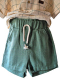 Green shorts with a drawstring on a white background