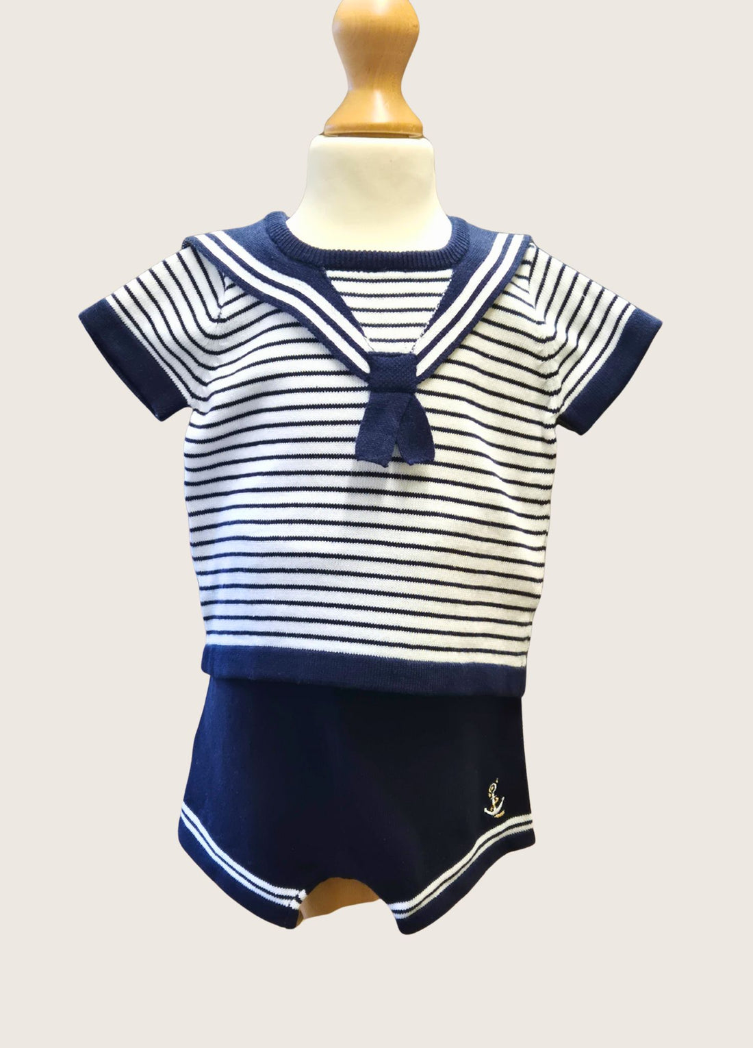 toddler boy in a navy and white striped sailor top and shorts set