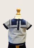 Nautical-style striped shirt on a mannequin against a plain background