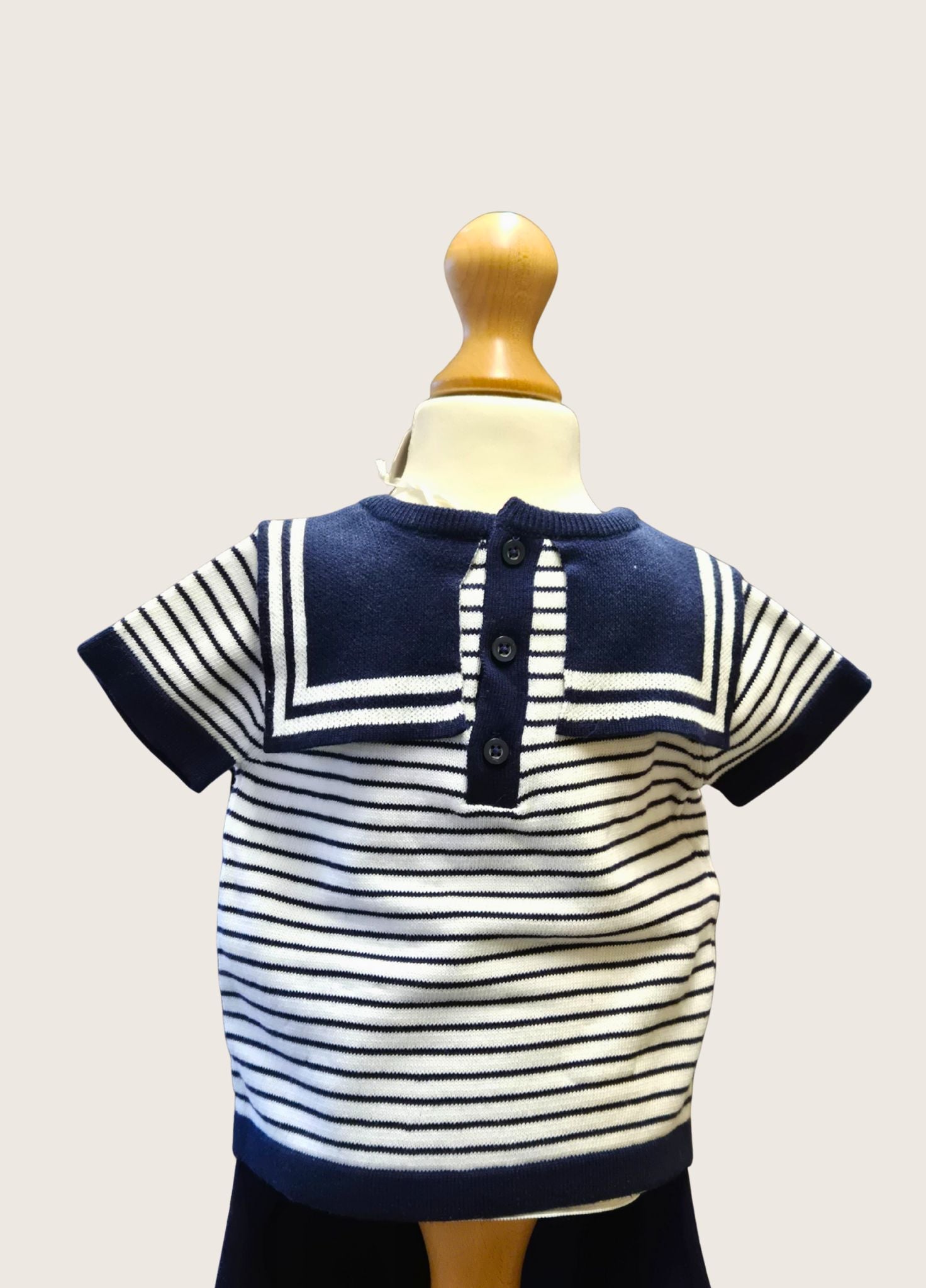 Nautical-style striped shirt on a mannequin against a plain background