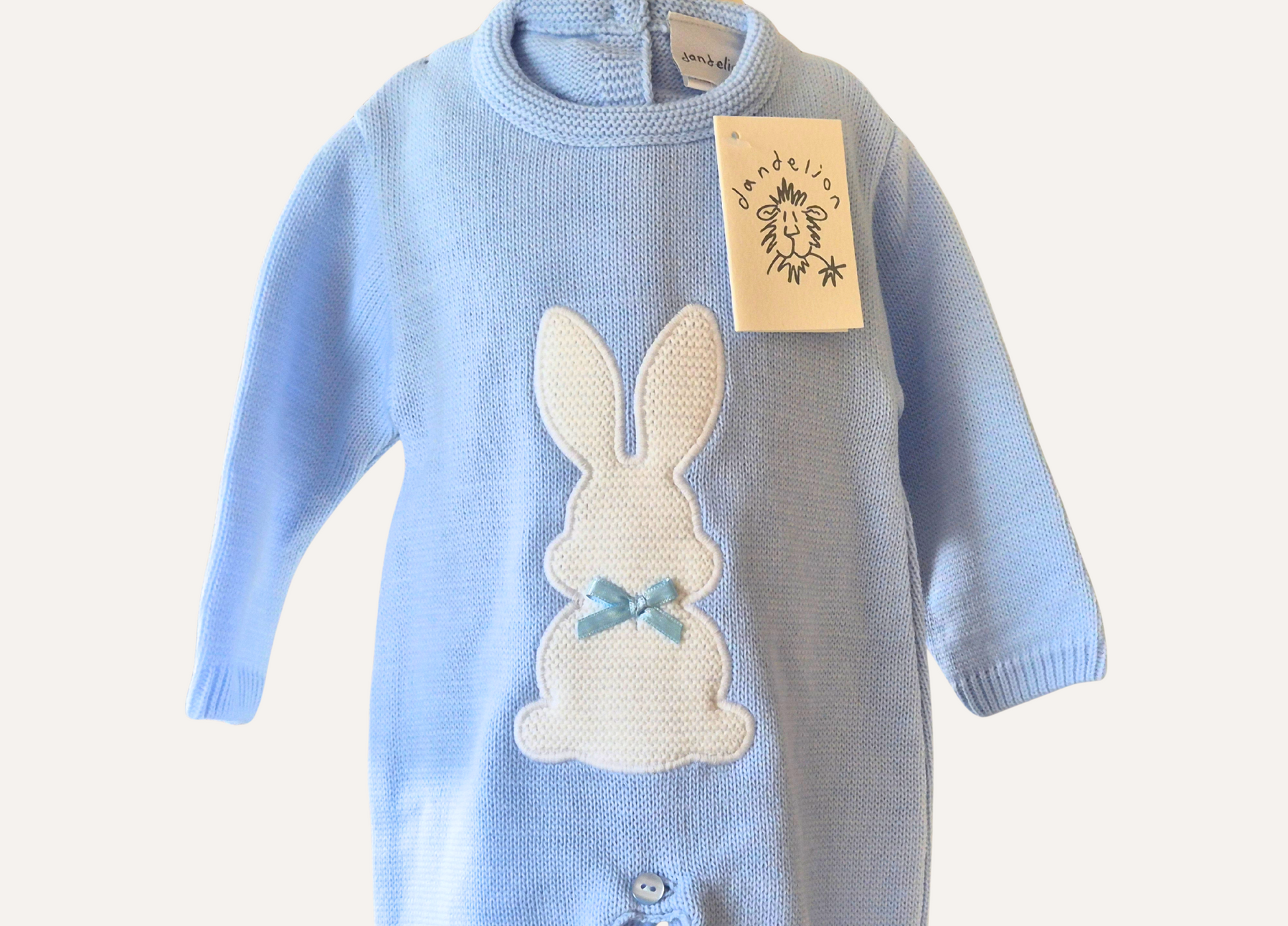 Close up detail of baby blue knitted romper from Dandelion with a white bunny motif