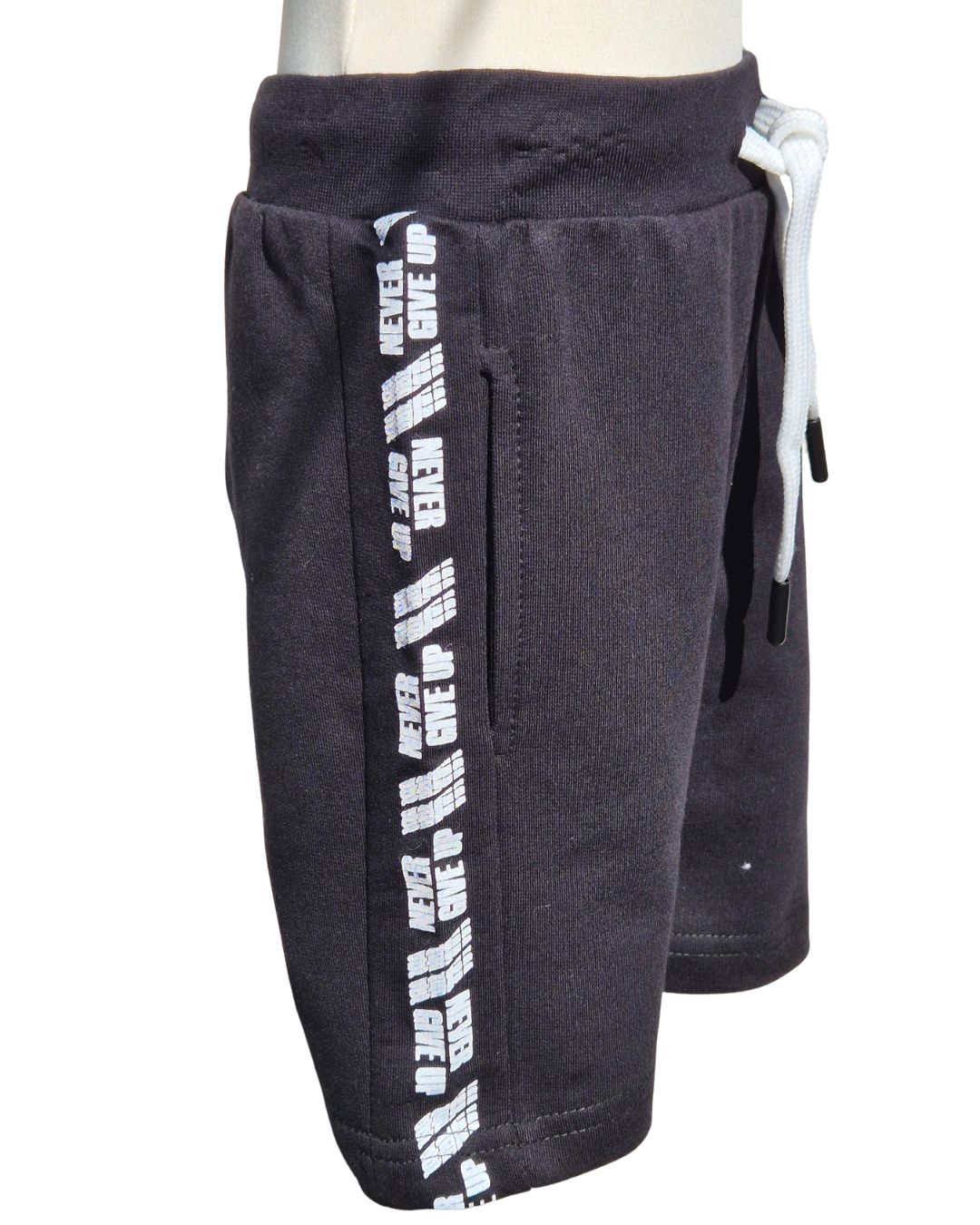 Black sweat shorts with white text on a white background