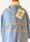 Baby blue knitted onesie from Dandelion with rocking horse motif