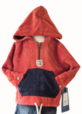 Rust corduroy hoodie with black pocket on a white background