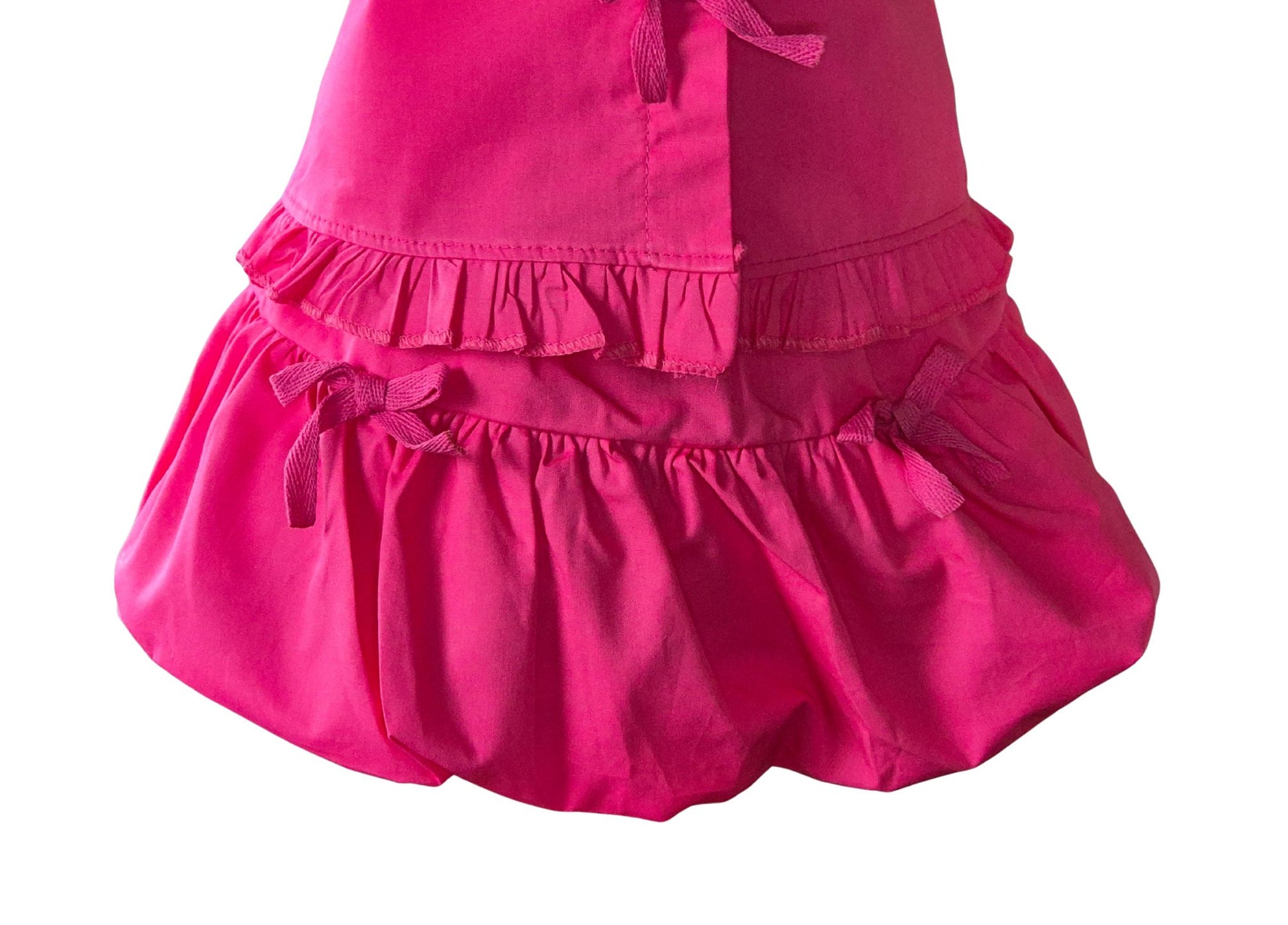 Pink skirt with ruffled layers on a white background
