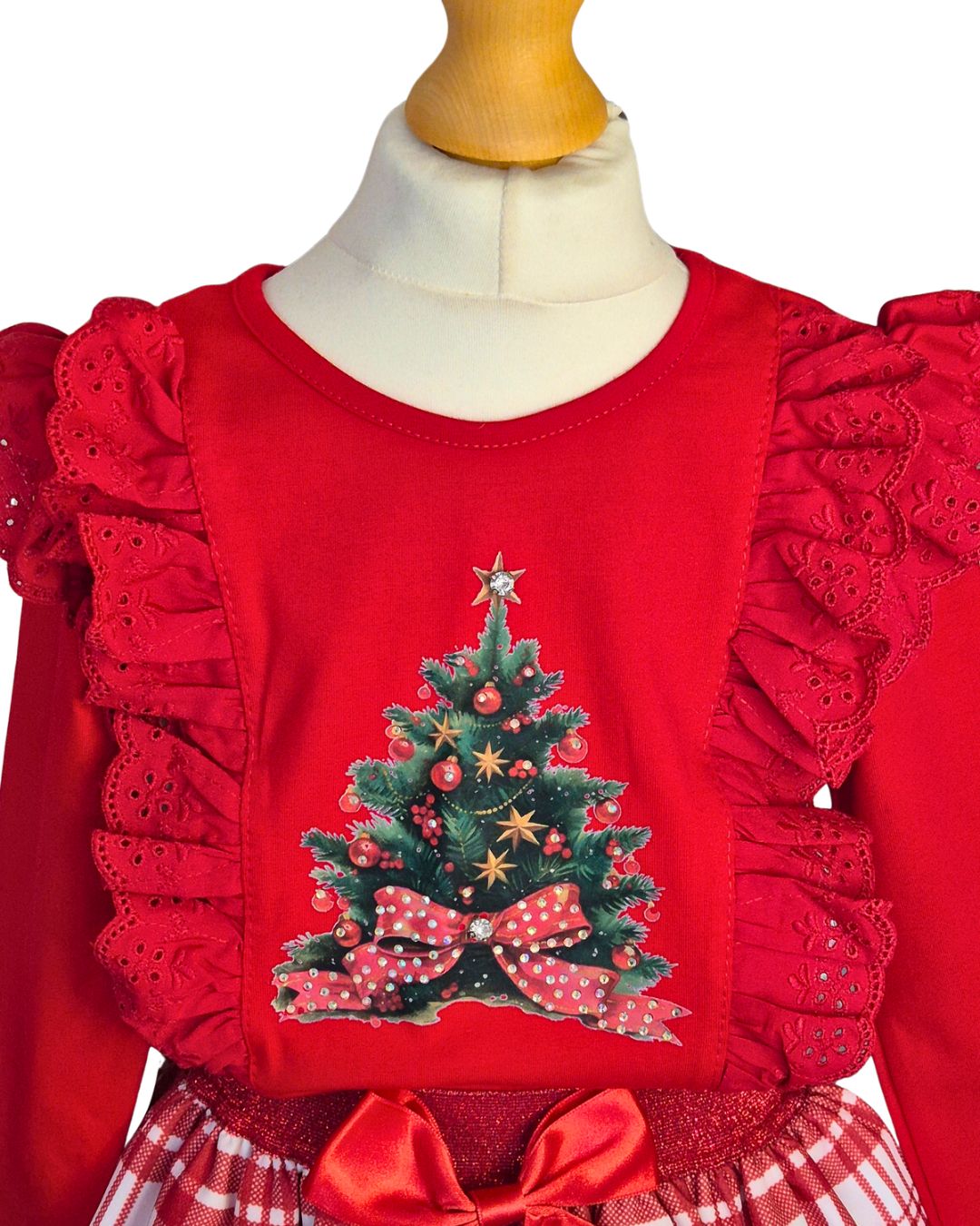 Red girls’ Christmas top with sparkling tree motif and frilled shoulders