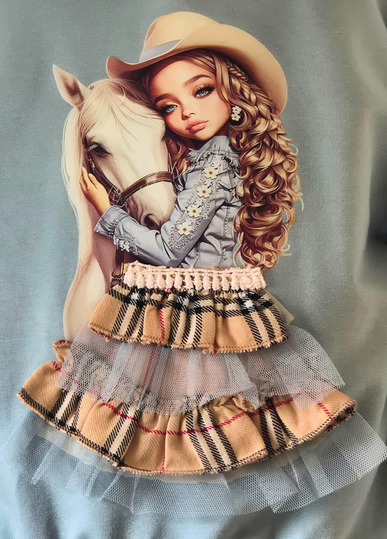 Illustration of a girl in a cowboy hat with a horse, wearing a plaid dress.