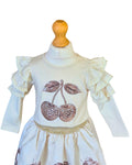 Girls cream top with sparkly cherry embellishment