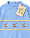 Blue knitted baby suit with three rocking horses on the chest