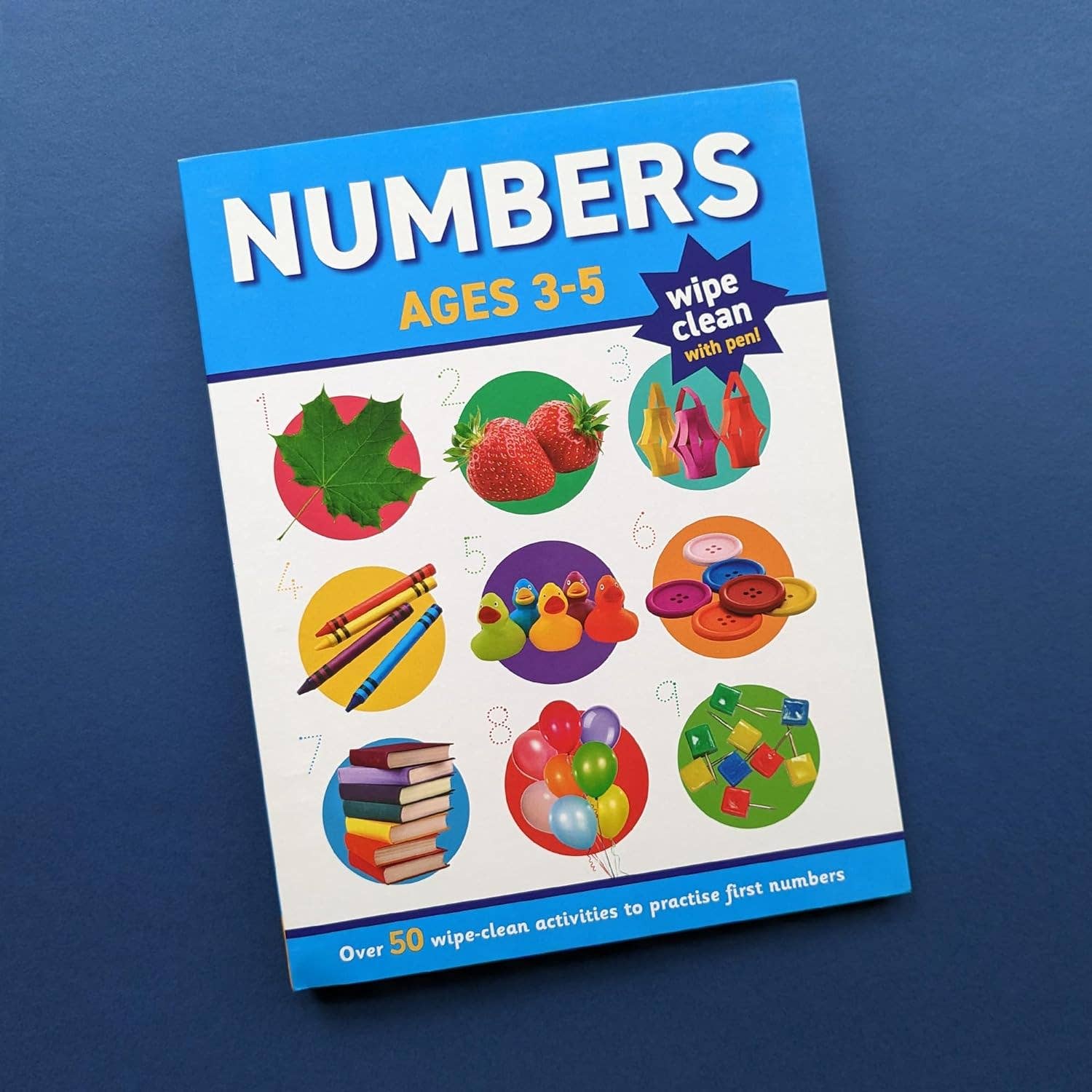 Book titled 'Numbers Ages 3-5' with colorful illustrations on a blue background