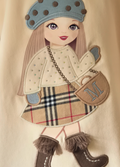 Further detail to show the sparkly jumper on the doll motif and the fringes on her boots.