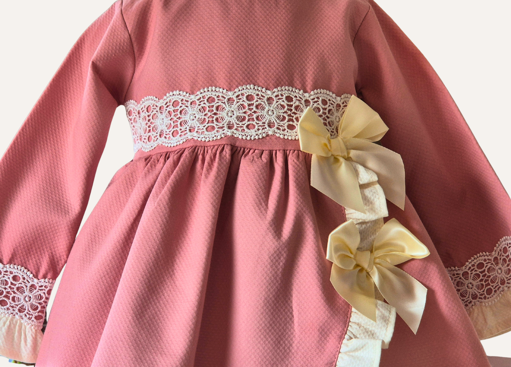 Girls spanish dusky pink frills and bows dress bodice detail