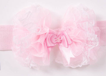 Pink Soft headband withPink bow with ruffles on a white background