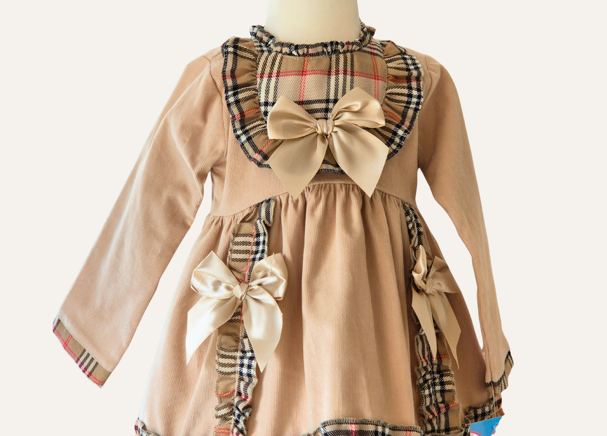 Bodice detail of the Spanish Beige Children's dress with plaid accents and bows