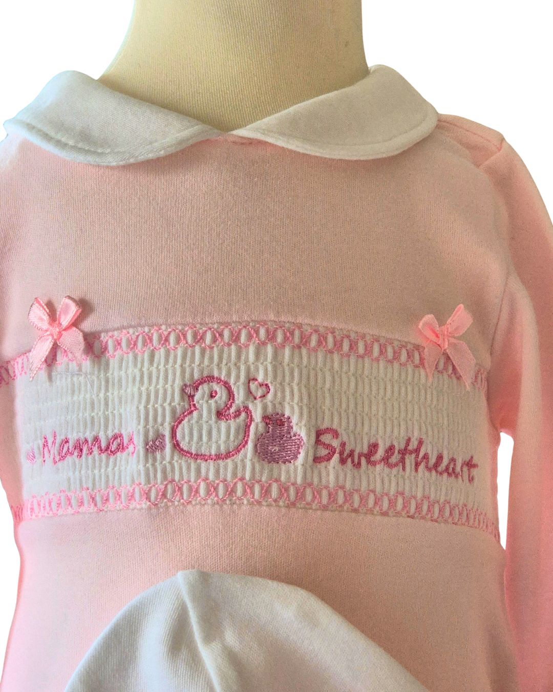 Pink baby sleepsuit with Peter Pan collar