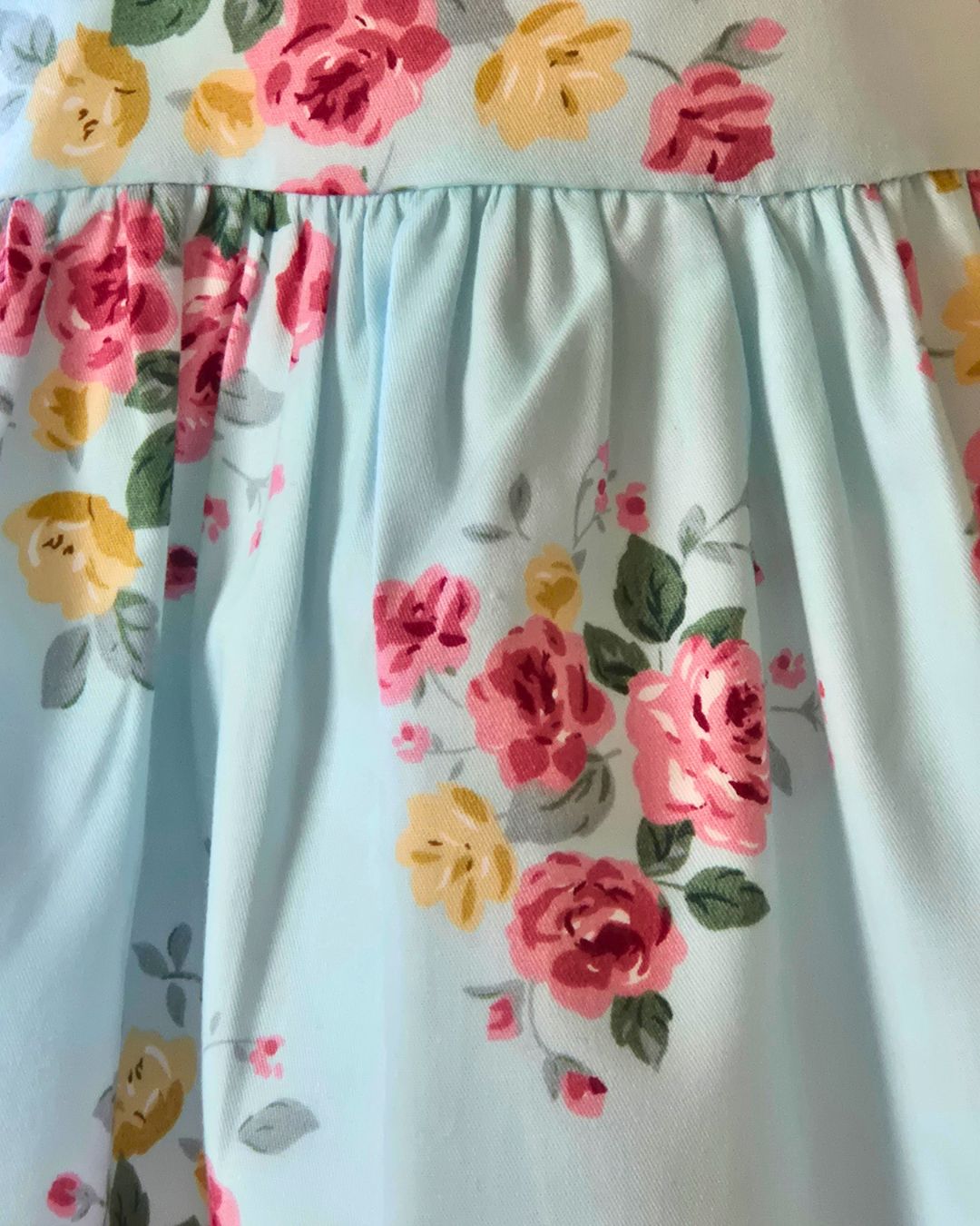 Soft blue girls dress with antique floral pattern