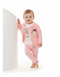 Baby girl modelling pink teddy bear outfit with lace jacket
