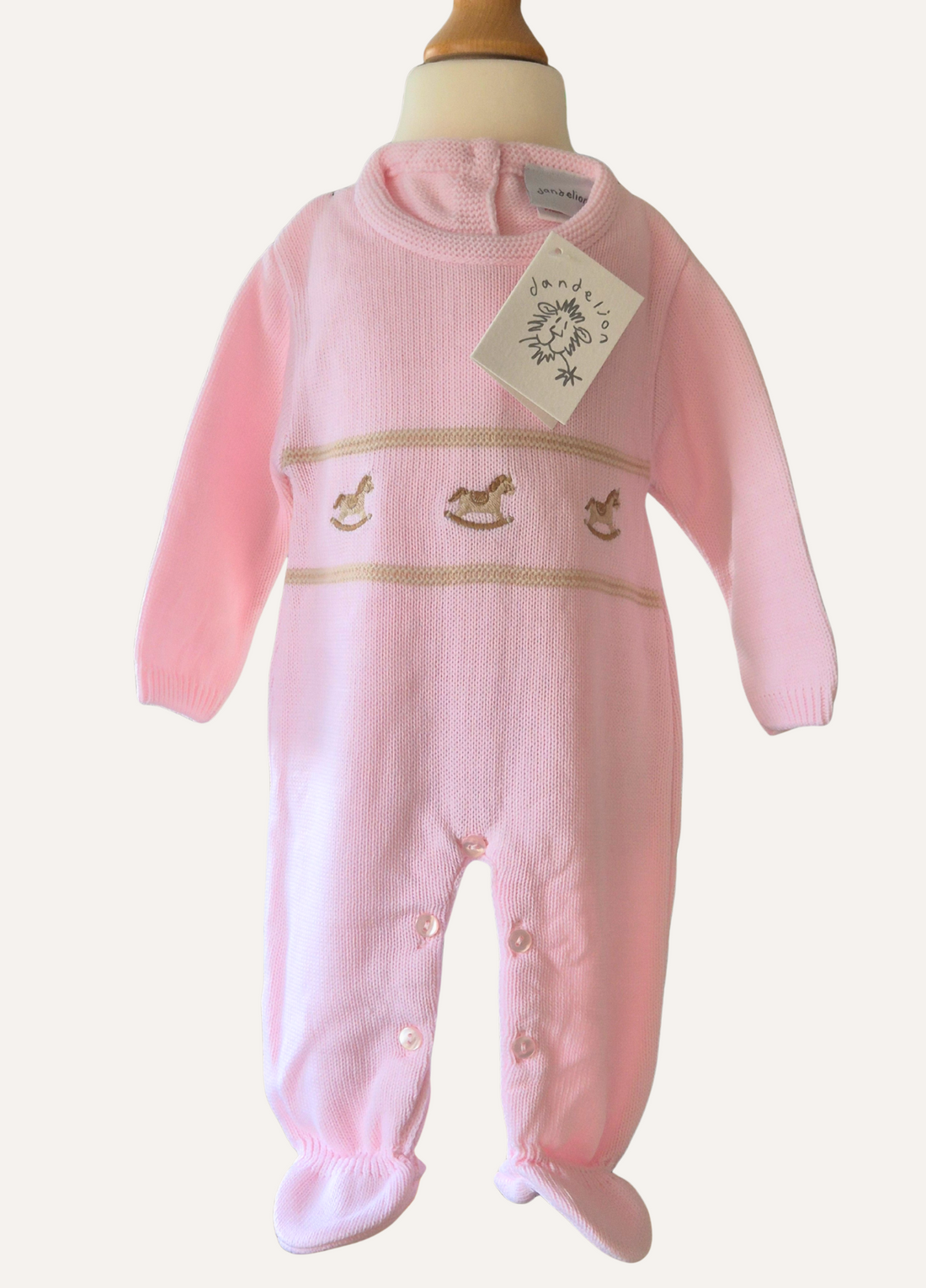 Baby Pink knitted onesie from Dandelion with rocking horse detail