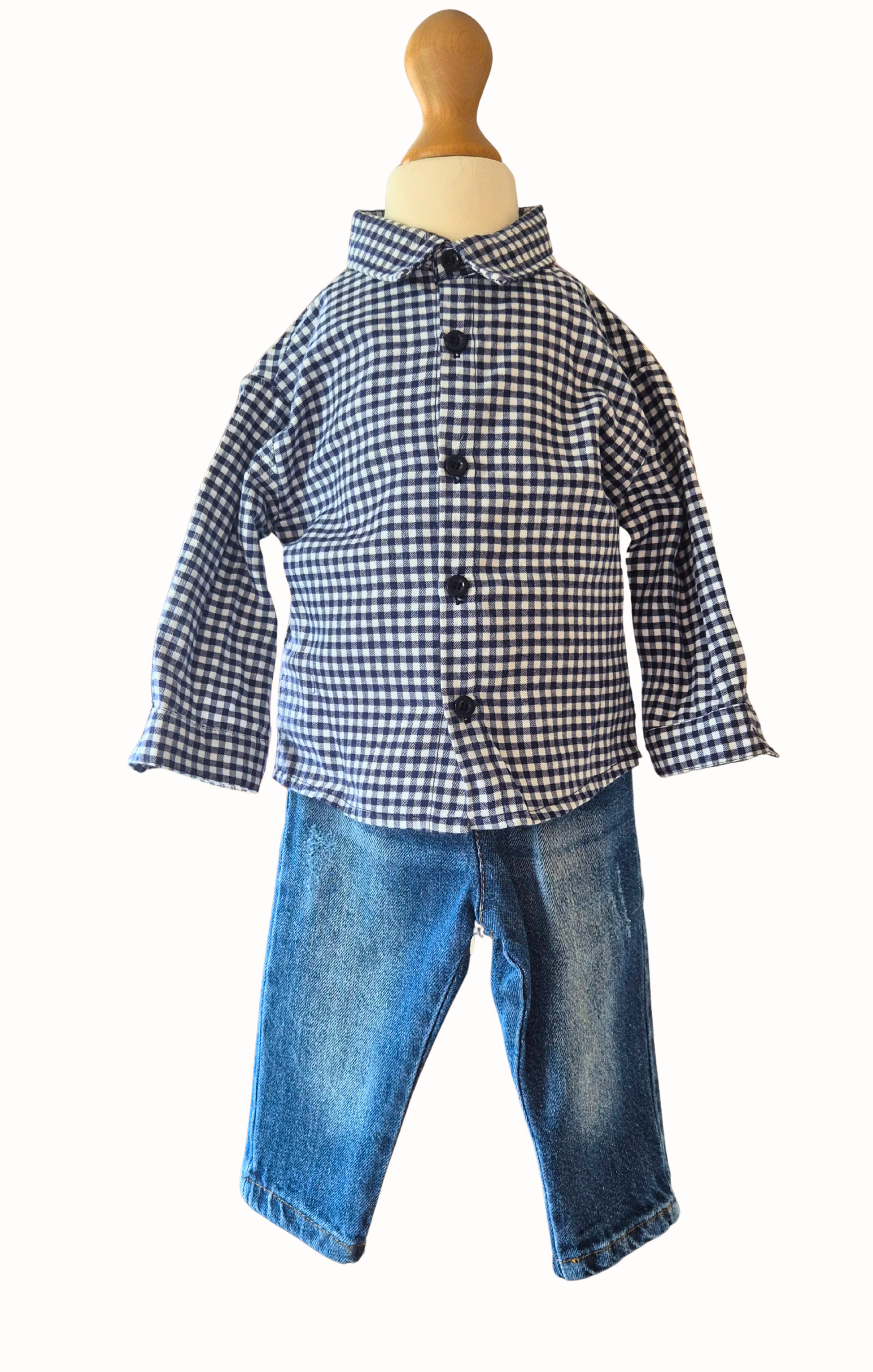Children's outfit with checkered shirt and jeans on a mannequin against a white background