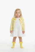 Lemon double bow cardigan on a blonde girl over a white frill dress