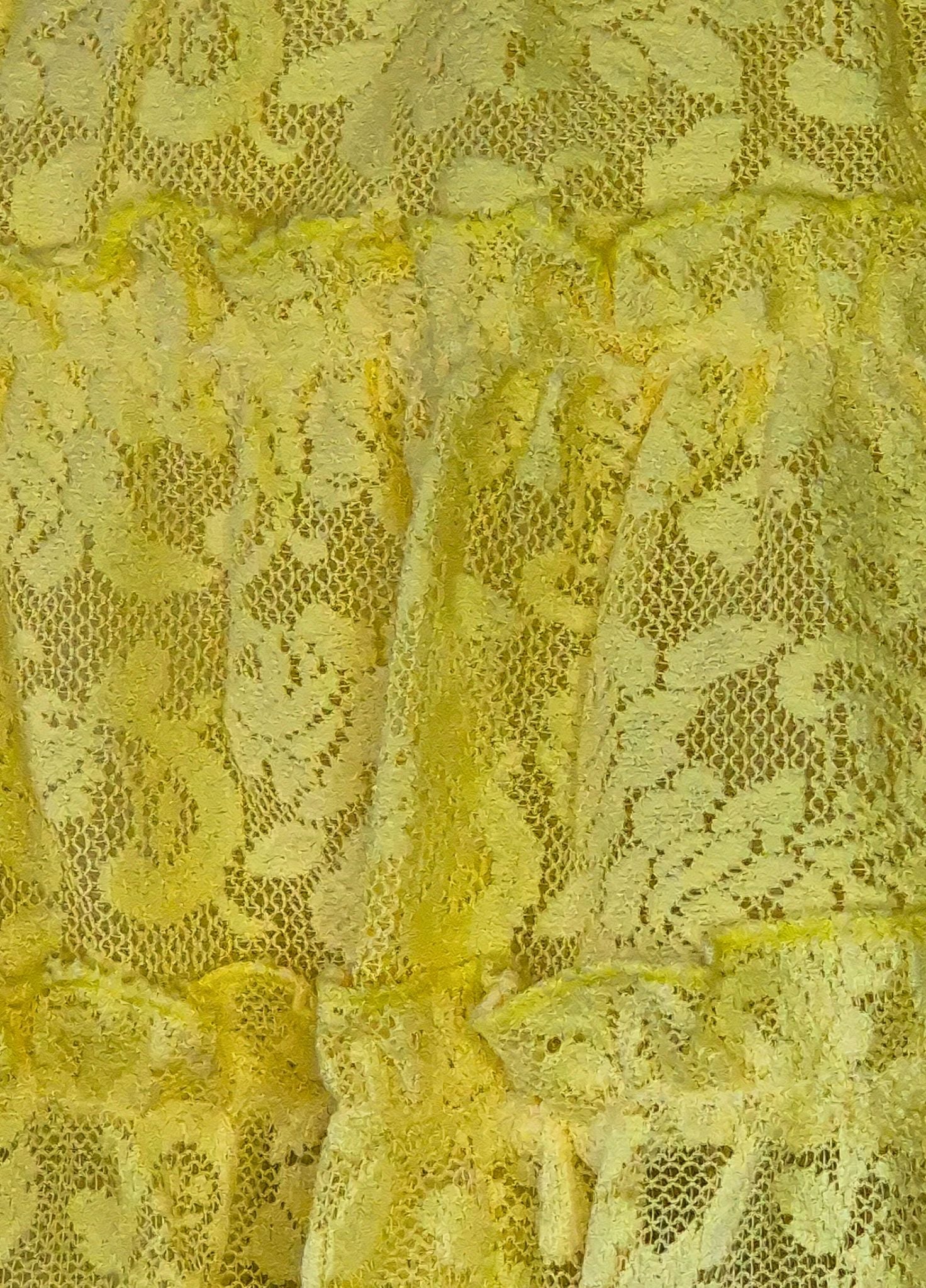 Close-up of yellow lace fabric with intricate patterns