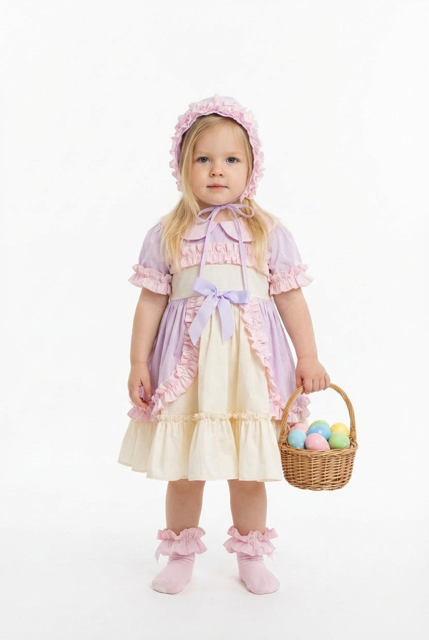 Young girl in a pastel dress holding a basket of Easter eggs on a white background