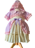 Pastel-colored dress with ruffles and a bow on a mannequin against a white background