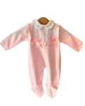 Pink cotton baby sleepsuit with white frilled bib