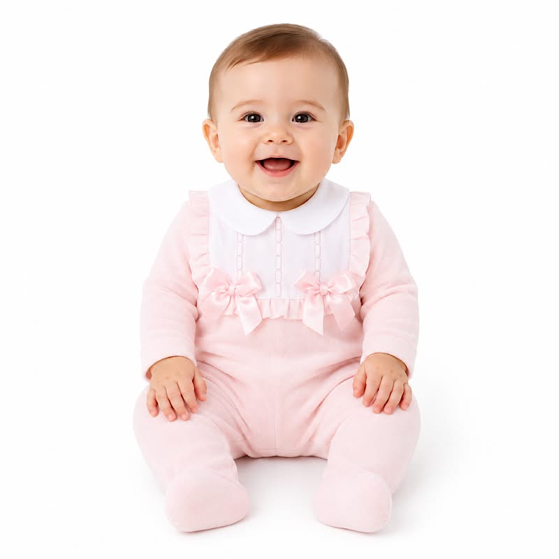 Pink cotton baby sleepsuit with white frilled bib
