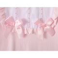 Pink baby sleepsuit with embroidered bib and bows