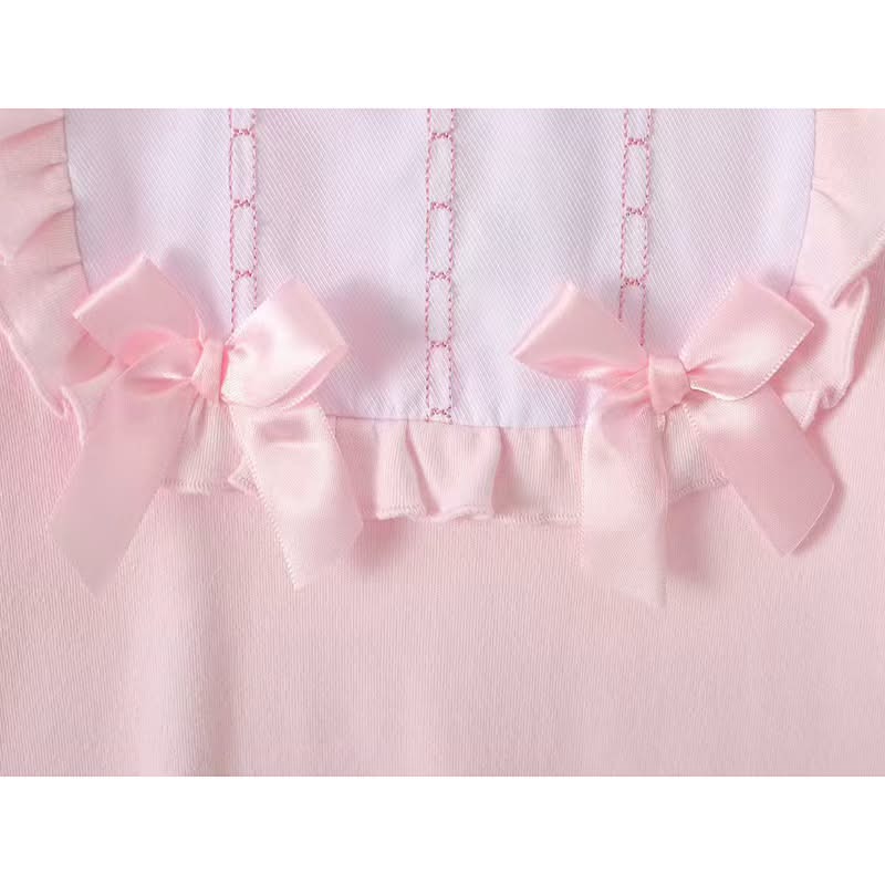 Pink baby sleepsuit with embroidered bib and bows