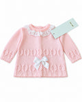 Pink baby jumper with white broderie anglaise collar and satin bow