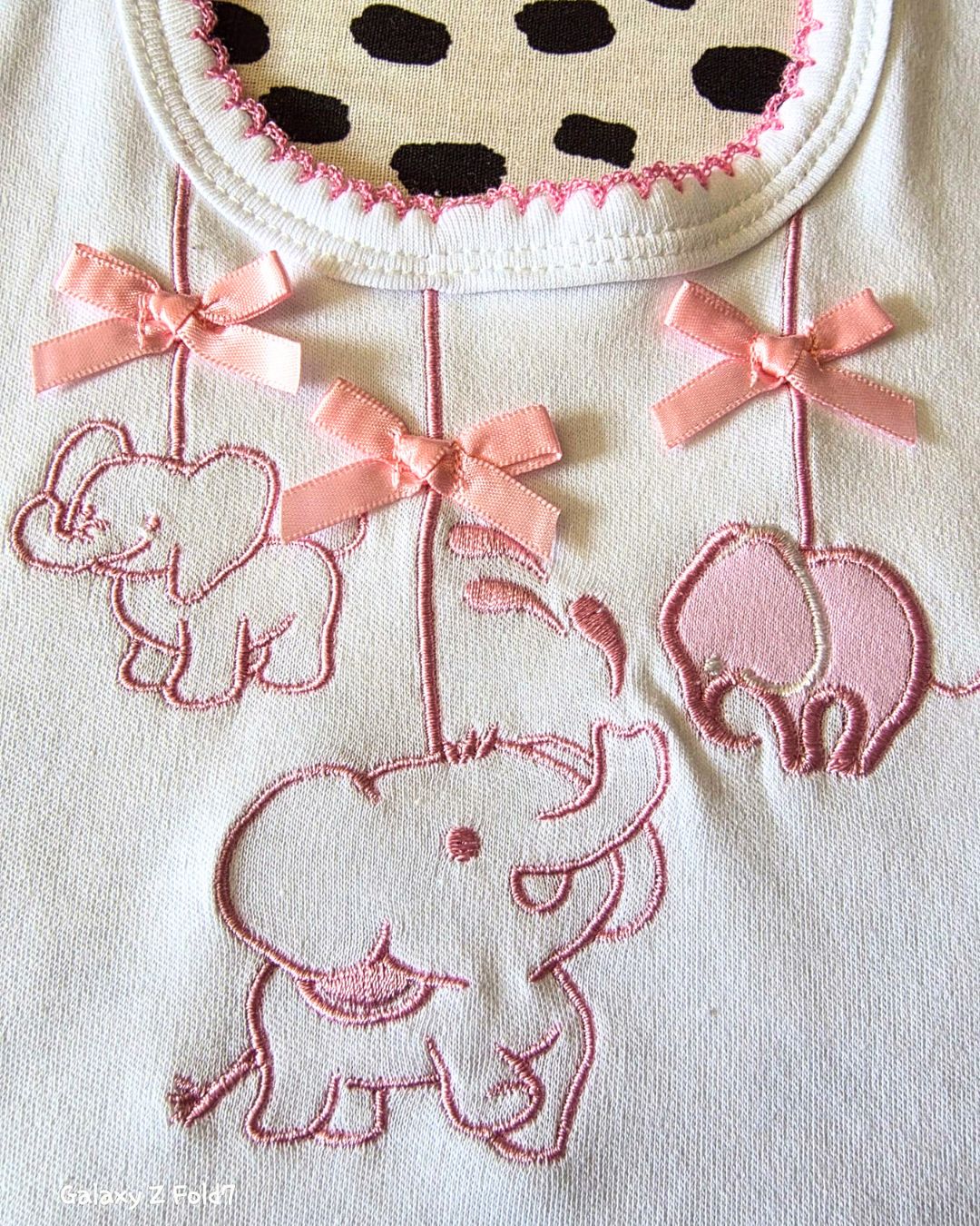 Baby bib with pink satin ribbon bow detail