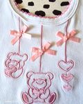 Baby bib with pink satin ribbon bow detail