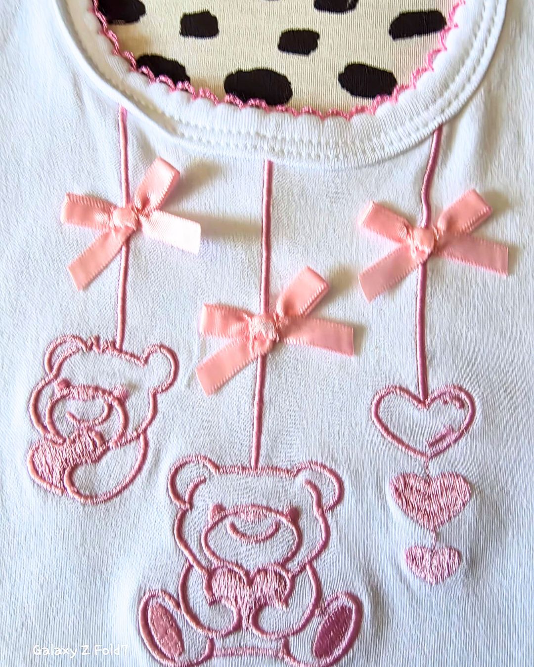 Baby bib with pink satin ribbon bow detail