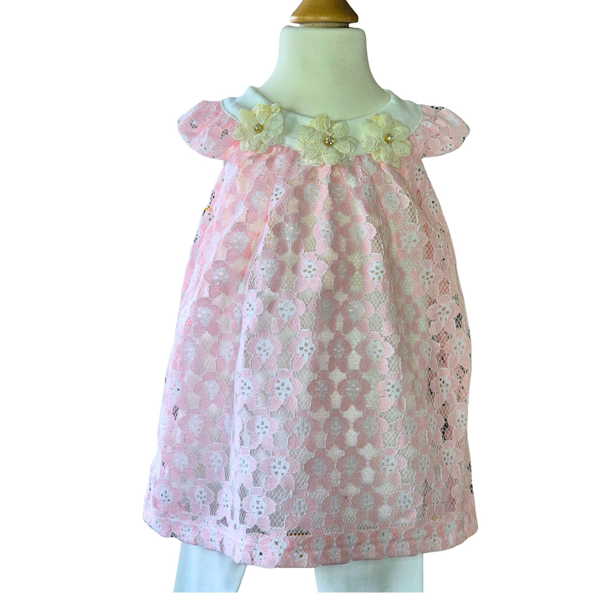 Pink floral lace dress on a mannequin with a white background