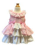 Pink and white tiered peplum  dress on a mannequin with a white background