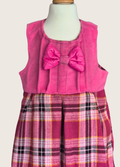 Pink sleeveless dress with a bow and plaid skirt on a mannequin against a white background